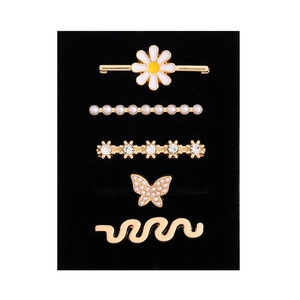 Five-piece gold watch band charms featuring daisy, pearl butterfly, and rhinestone star