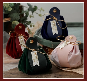 Velvet drawstring gift bags in multiple colors with gold buckles and pearl charms