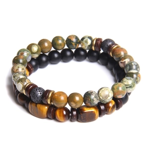 Close-up of stacked beaded bracelets with tiger eye, black matte beads and lava stones