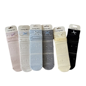 Six pairs of bow-knot mesh crew socks in assorted colors with heart patterns
