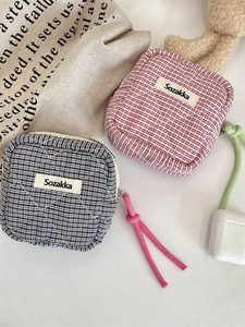 Quilted checkered mini storage pouches in black and red patterns with cord zipper pulls