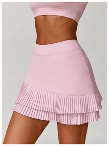 Detailed view of the double-layered pleated hem of a high-waisted pink sports skirt