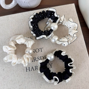 Set of four black and white polka dot scrunchies with elegant pearls and lace edges