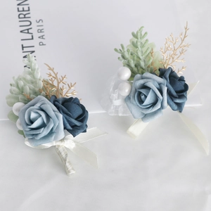 Blue silk rose boutonniere set with pearls and gold leaf accents for wedding guest attire