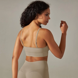 Detail view of seamless knit yoga set showing breathable mesh texture and cross back straps