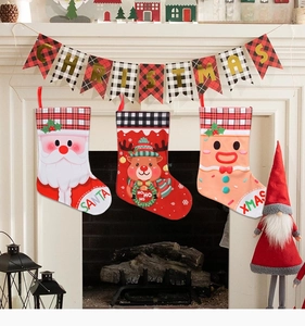 Three festive Christmas stockings with Santa, reindeer and gingerbread man on a fireplace