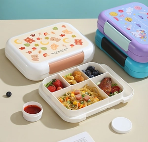 Detail view of 4-compartment lunch box with cute bear pattern and sauce container
