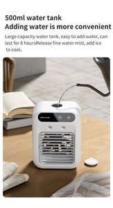Close-up of a white mini air cooler with a 500ml water tank on a wooden office desk