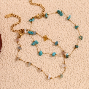 Detail of 18K gold-plated stainless steel anklet with colorful natural gravel stones