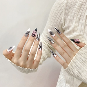 Handmade long stiletto press-on nails with pink 3D spiders and silver bow punk design