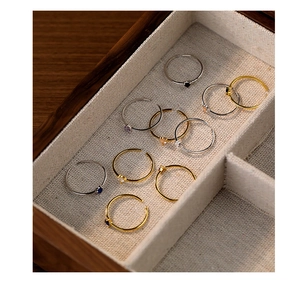 Close-up of minimalist S925 sterling silver rings with colorful heart-shaped cubic zirconia