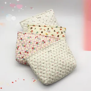 Quilted floral and bear pattern toiletry bags in four colors with diamond stitching detail