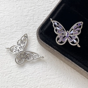 Close-up of 14k gold-plated butterfly charms with purple zircon inlay for DIY jewelry