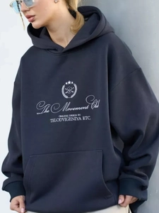 Detail of navy blue hoodie featuring letter print and spacious front kangaroo pocket