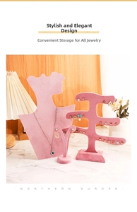 Pink velvet jewelry display set featuring necklace bust and earring holders on marble top