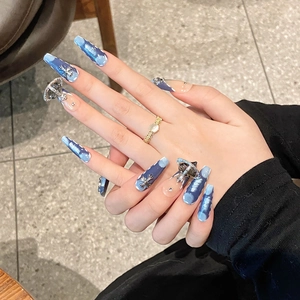 Y2K blue ombre press-on nails featuring 3D metallic cross and saturn charms