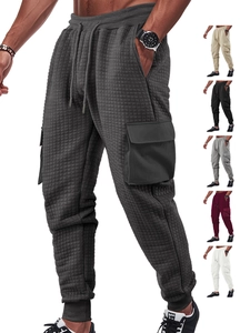 Detail of waffle knit fabric and cargo pocket design on men's jogger pants