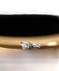 Macro shot of silver ring featuring square diamond center and chain link band details