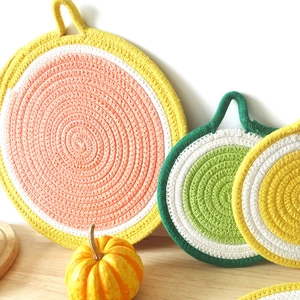 Nordic fruit-themed woven cotton placemats with hanging loops in lemon and orange designs