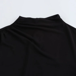 Detail of elegant black knitted dress featuring a mock neck and smooth textured fabric