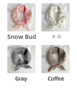 Detail showing smiley print bibs in snow bud, off-white, grey and coffee colors