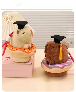Detailed view of capybara plush keychains with graduation caps and colorful donuts