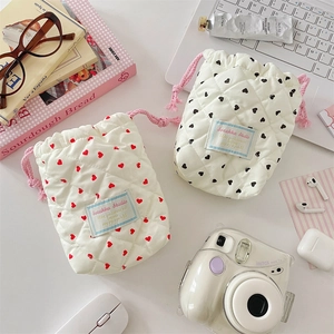 Close-up of quilted heart pattern storage bags with secure drawstring closure for cameras