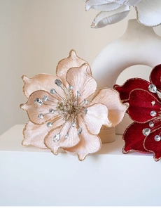 Close-up of velvet magnolia flowers with gold glitter edges and crystal rhinestones