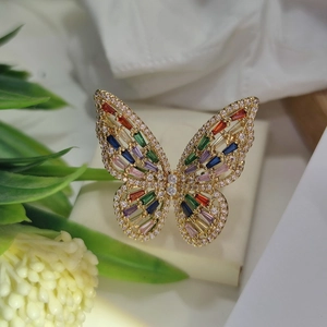 Detail of a gold butterfly ring featuring multi-color gemstones and sparkling cubic zirconia