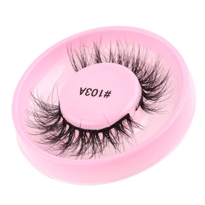 Detailed close-up of dense 3D black false eyelashes style 103A on a pink round tray
