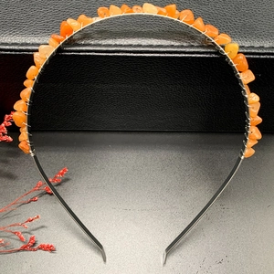 Detail of handcrafted silver headband with orange crystal chips and wire wrapping