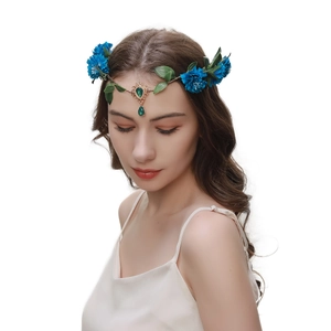 Detail of baroque forehead pendant headband with blue flowers, green leaves and gold charms