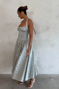 Detail of light blue floral halter maxi dress showing flowing fabric and pattern