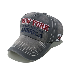 Detail of grey washed cotton baseball cap with New York 3D embroidery and white stitching
