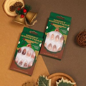 Christmas theme press-on nails with snowflake and glitter patterns in holiday packaging