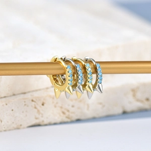 Punk style hoop earrings with spikes and blue turquoise stones in gold and silver finish