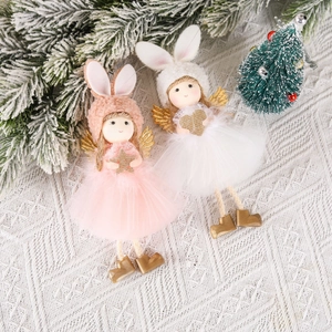 Pink and white Christmas angel dolls with mesh skirts and gold wings on snowy pine branches