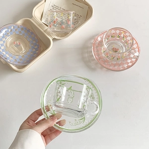 Floral glass coffee cup and checkered saucer set in green, pink, and blue colors
