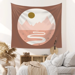 Detail of bohemian tapestry featuring abstract pink mountains and sun in a cozy bedroom
