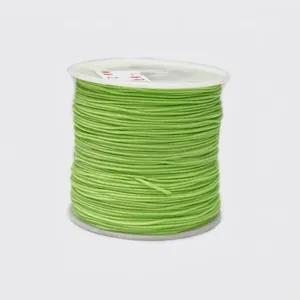Detail view of 0.8mm bright green nylon cord roll for jewelry making and hand weaving