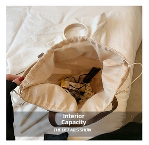 Top view detail of large straw bag interior showing drawstring closure and spacious storage