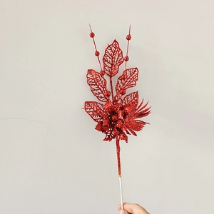 Detailed view of red glittery Christmas tree floral pick with hollow leaves and berries