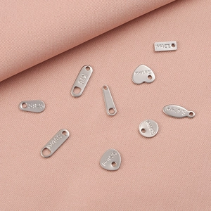 Detailed close-up of S.steel K18 and S925 heart and oval jewelry connector charms