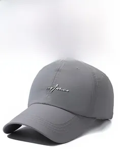 Detail of gray quick-dry baseball cap featuring white embroidery and reinforced stitching
