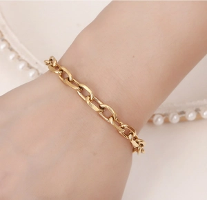 Close-up of minimalist 18K gold-plated paperclip link bracelet on female wrist