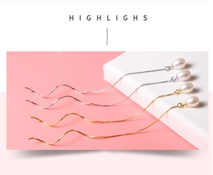 Detailed close-up of elegant S925 silver and gold wave chain pearl drop earrings
