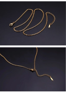 Detail of golden stainless steel cross chain with lobster clasp and S.STEEL tag