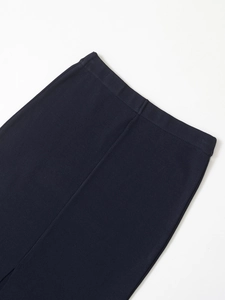 Detailed close-up of high-quality waist stitching on navy satin midi skirt fabric