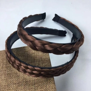 Brown braided wig headband with anti-slip teeth shown on a textured display surface