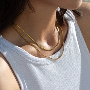 Detail view of 18K gold plated herringbone and round snake chain necklace set